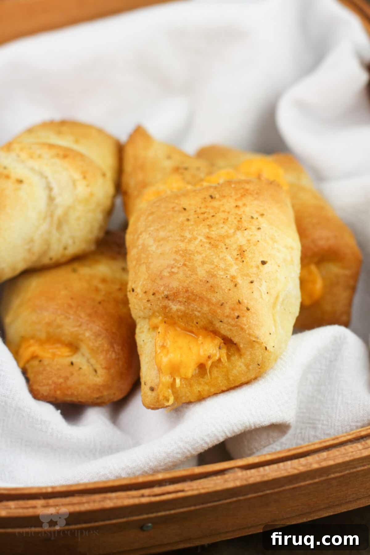 Melted Cheddar Crescent Rolls 3 Freshly baked Old Bay crescent rolls in a basket, showcasing their golden-brown exterior.