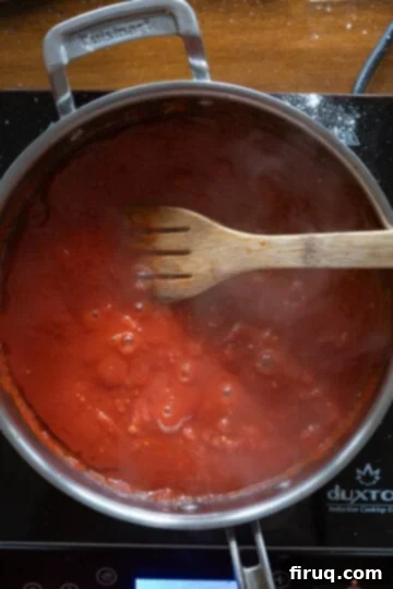 Dreamy Creamy Chicken Parmesan Pasta 6 sauce simmering