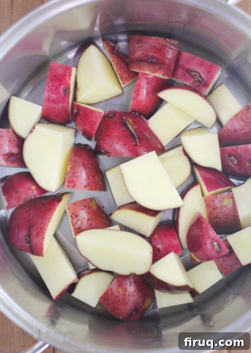 Creamy Ranch Mashed Potato Cups 4 chopped red potatoes in metal pot, ready for boiling