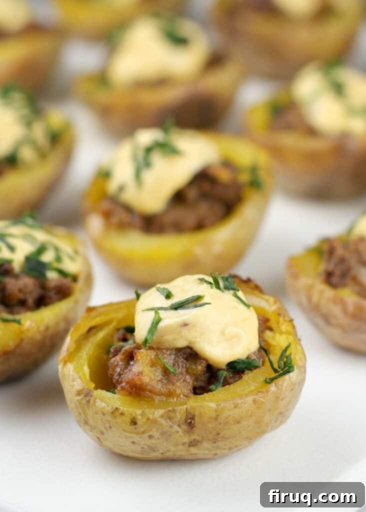 Creamy Ranch Mashed Potato Cups 6 mini potato skins on white dish, showcasing Mini Cheeseburger Potato Bites