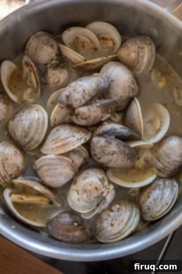 Coastal Linguine with Tender Clams 6 simmering clams in a pot for linguine