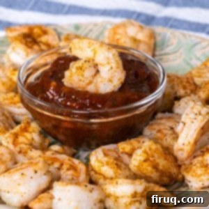 Zesty Homemade Shrimp Cocktail Perfection 10 Perfectly cooked shrimp cocktail dipped in a vibrant homemade cocktail sauce, ready to enjoy