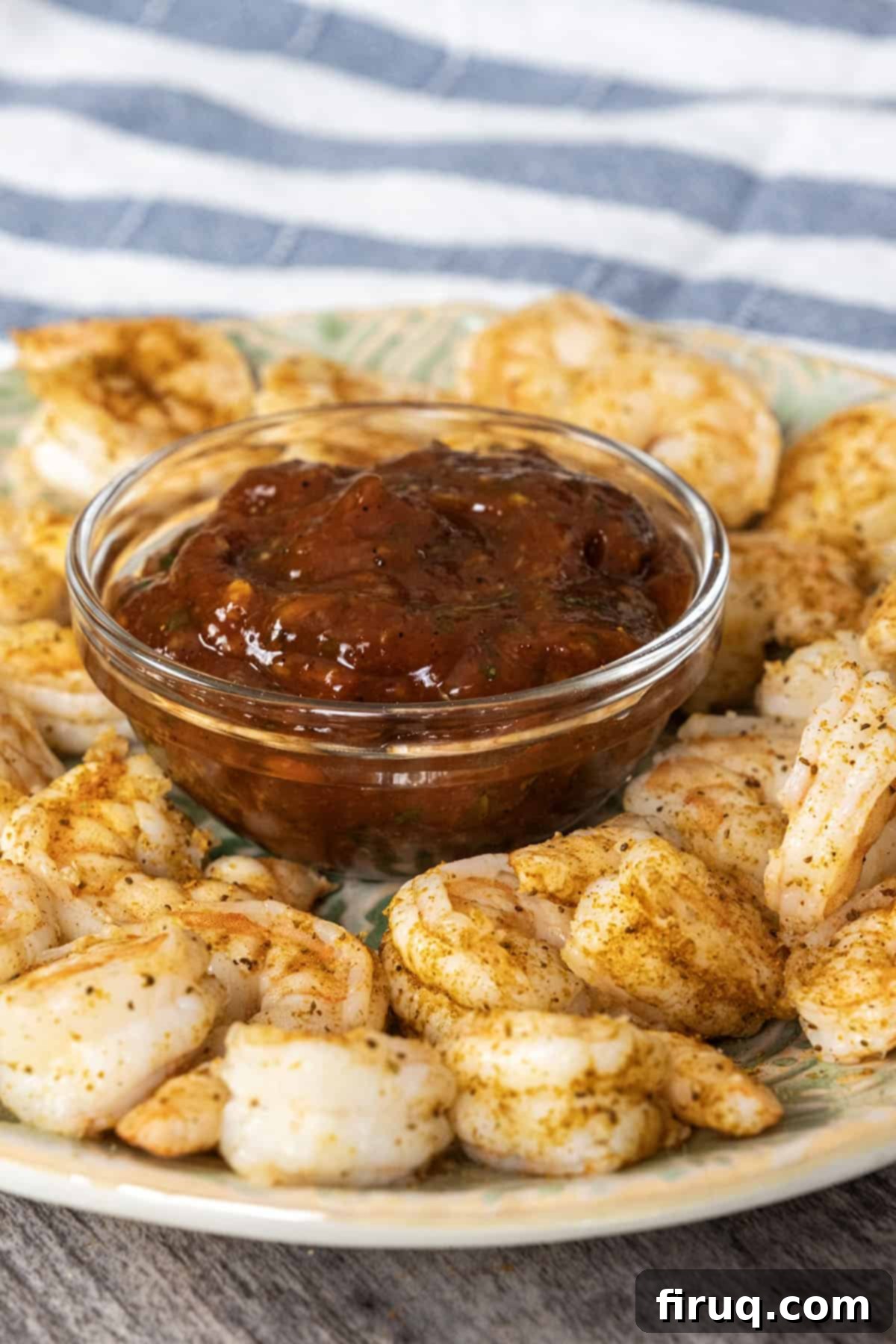 Zesty Homemade Shrimp Cocktail Perfection 9 Beautifully arranged homemade shrimp cocktail with a bowl of spicy cocktail sauce and Old Bay seasoning on the side
