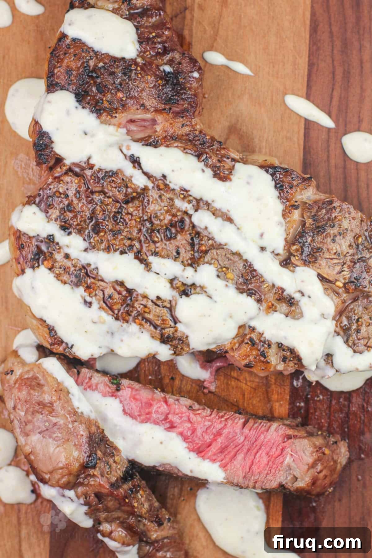 Grilled Steak with Zesty Horseradish Dijon 8 A beautifully cut and perfectly cooked steak on a wooden board, generously topped with creamy horseradish Dijon sauce, ready to be served.