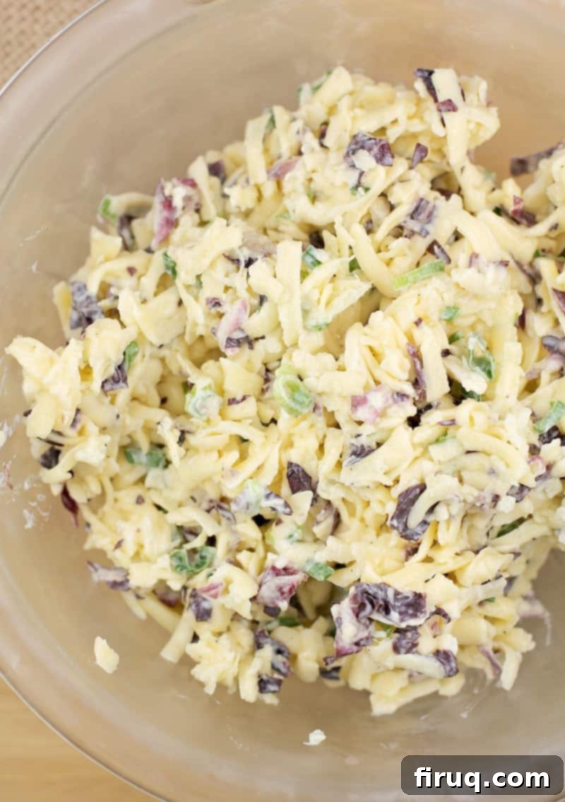 Imperial Russian Garlic Cheese 5 The fully mixed Russian garlic cheese spread in a clear glass bowl, showcasing its creamy texture and readiness to be served as an easy appetizer for a crowd.