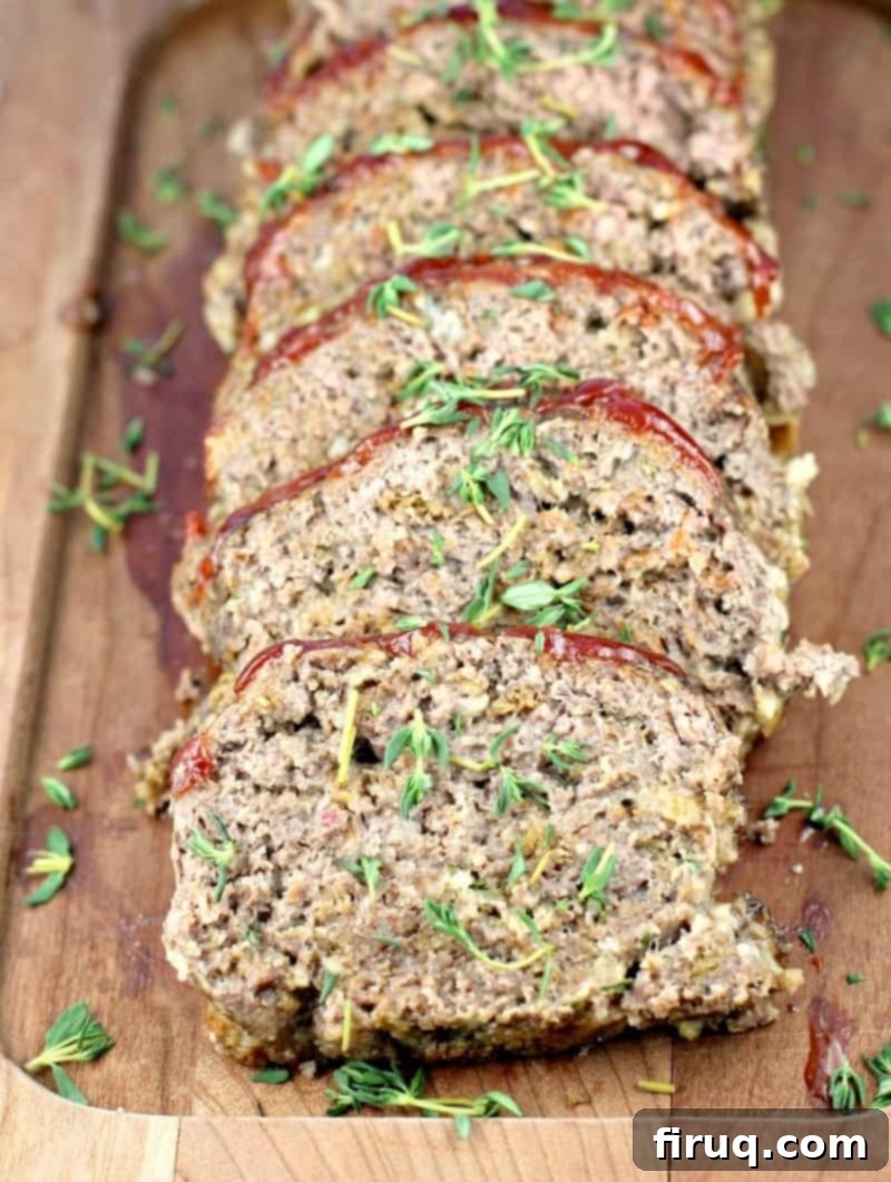 Mom's Meatloaf 9 sliced mom's meatloaf layered on a wood board
