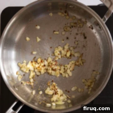 Mussels Infused with White Wine 5 Garlic and shallots sauteing in a pan with seasoning.