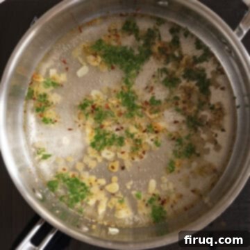 Mussels Infused with White Wine 6 White wine and parsley in a pan coming to a simmer.