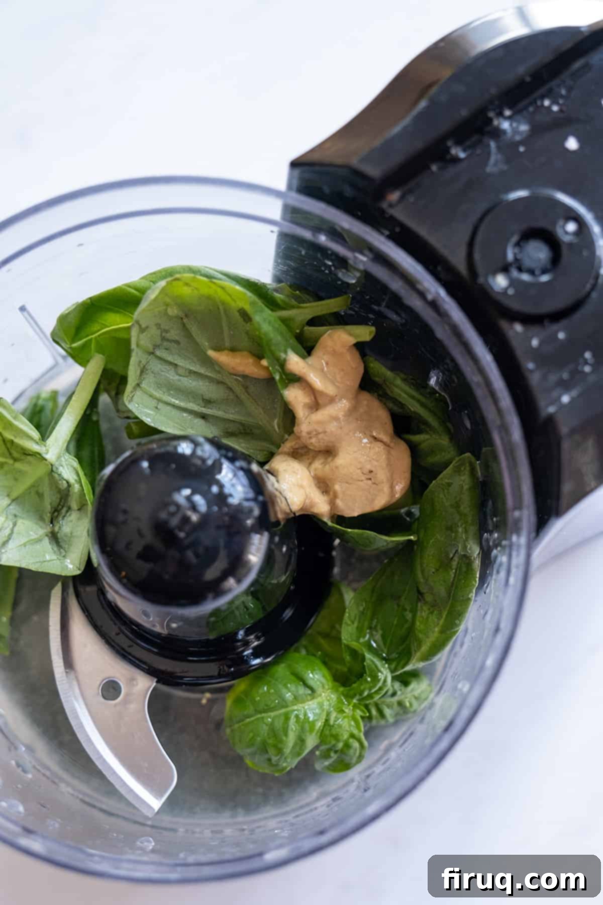 Zesty Basil-Lemon Dressing 3 lemon basil vinaigrette ingredients being processed in a food processor