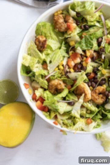 Zesty Mango-Lime Grilled Shrimp Salad 7 Finished grilled shrimp salad with mango dressing in a large bowl.