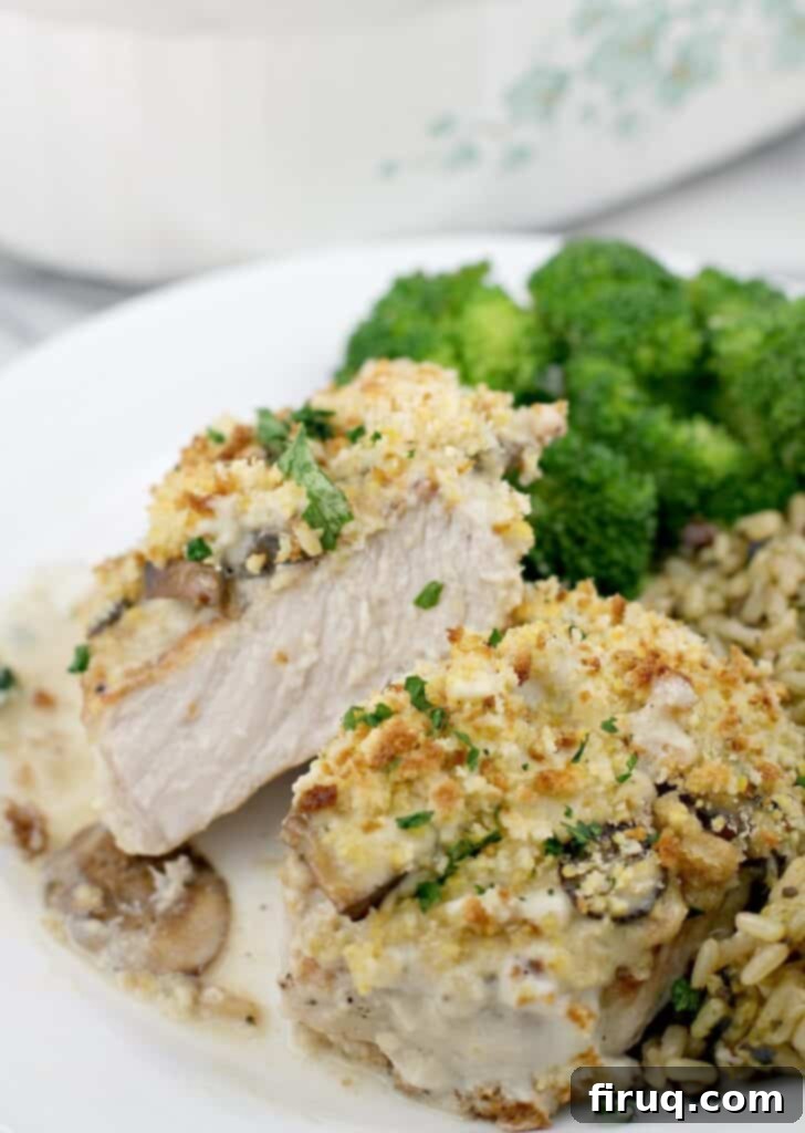 Hearty Pork Chop and Cornbread Bake 3 front view of finished pork, cut to show doneness plated on serving plate, rice and broccoli in the background