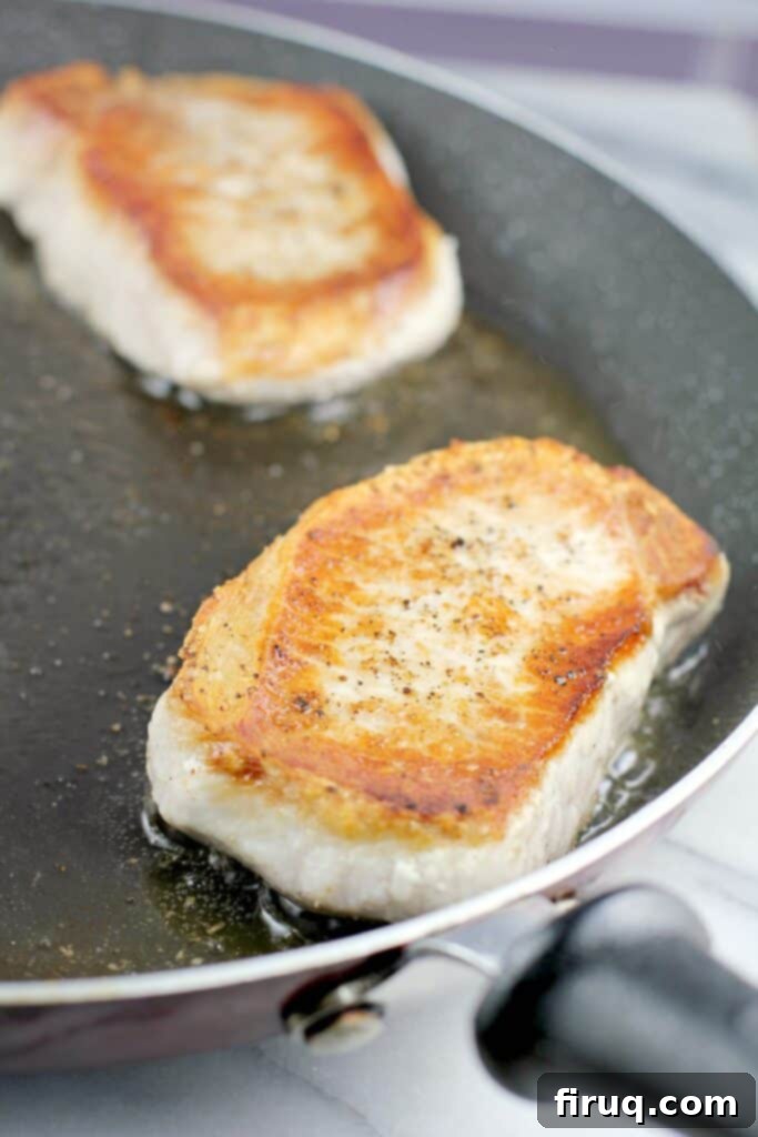 Hearty Pork Chop and Cornbread Bake 5 pork chop searing in a skillet to show browning