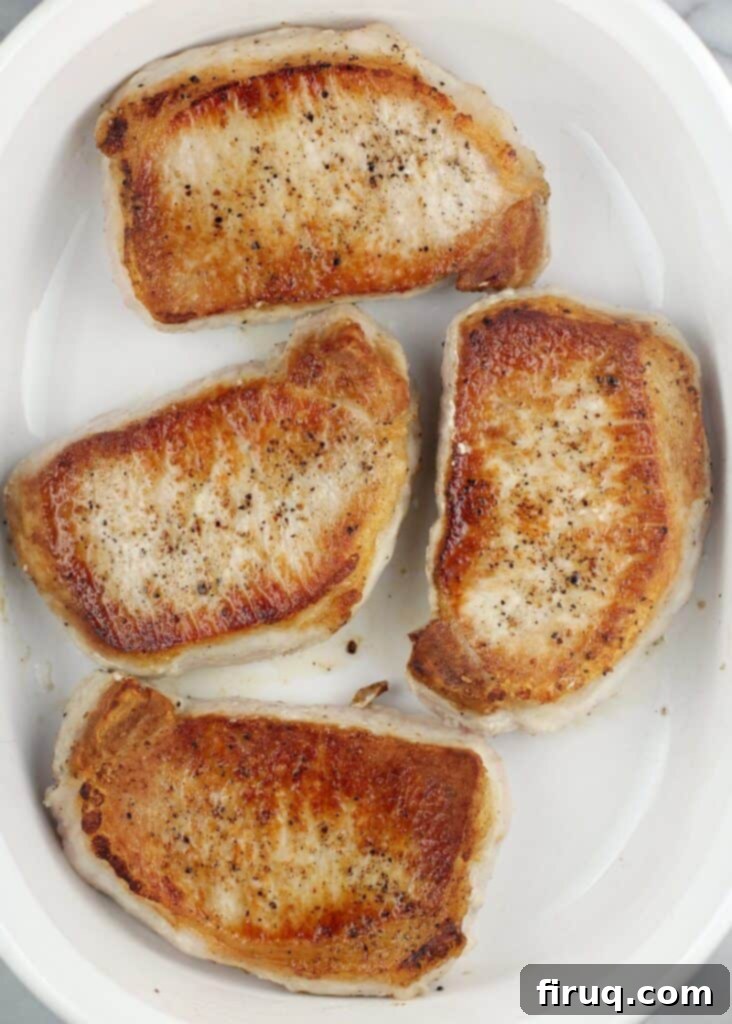 Hearty Pork Chop and Cornbread Bake 6 top view of seared boneless chops in a casserole dish