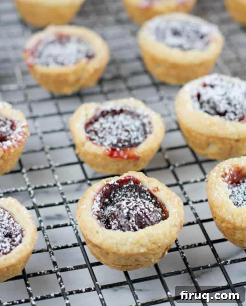 Velvet Cherry Cookie Tarts 9 finished cherry cup cookies on a cooling rack over a marble board