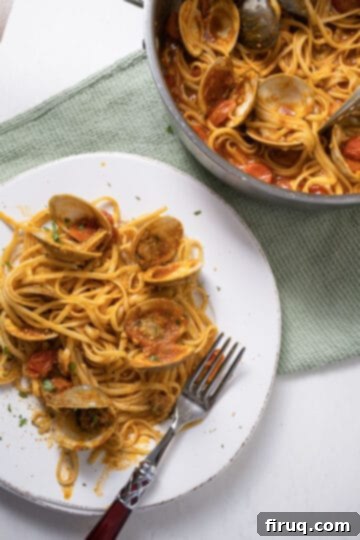 Christmas Eve's Seven Fishes Feast 10 linguine with clams in red sauce on a plate.
