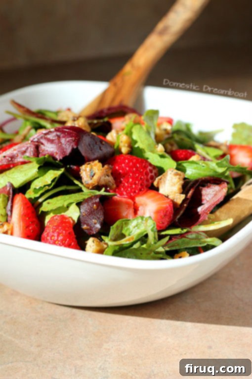 Ready-to-Serve Strawberry Salad A serving of Strawberry Salad with Lightly Candied Walnuts and Rosemary Balsamic Dressing, ready to eat.