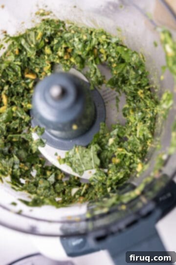 Emerald Pistachio Pesto 5 The food processor with the basil, pistachios, garlic, salt, and lemon juice pulsed into a coarse, bright green mixture.