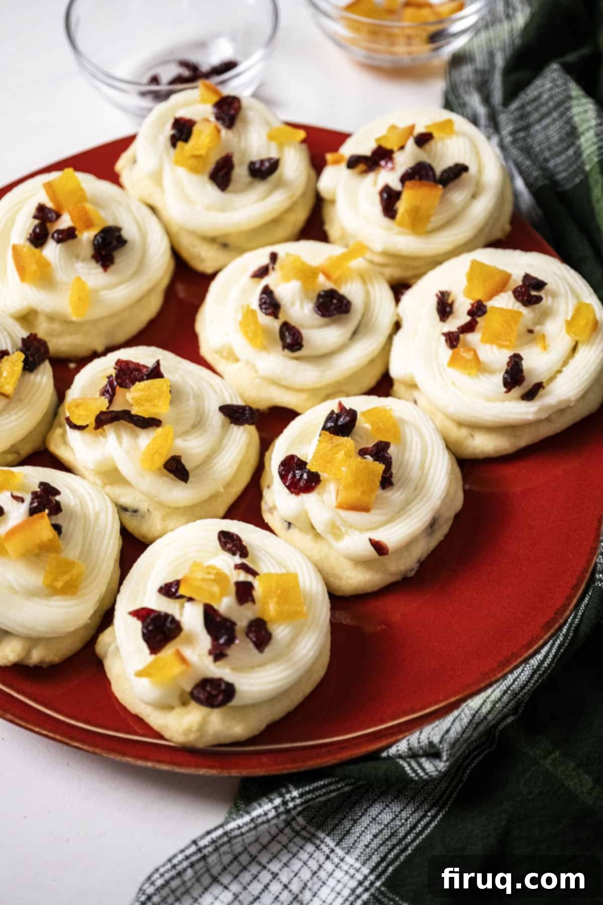 Citrus Cranberry Shortbread Morsels 11 Cranberry and orange shortbread cookies topped with frosting and garnished with dried cranberries and candied oranges.