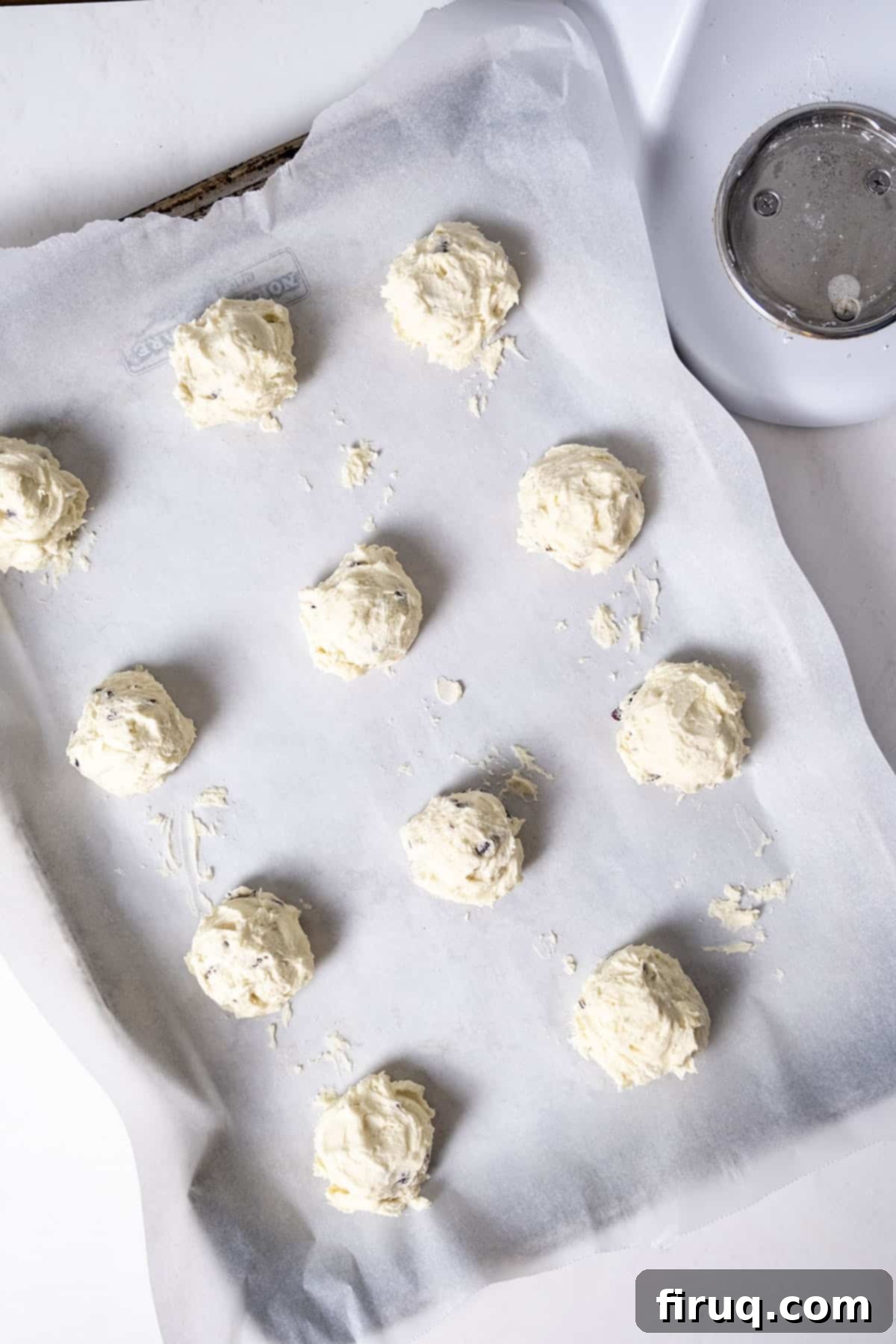 Citrus Cranberry Shortbread Morsels 7 Cookie dough on a parchment paper lined baking tray.