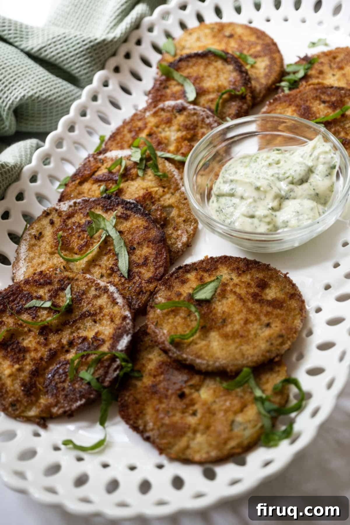 Crispy Italian Fried Green Tomatoes 2 Crispy Italian fried green tomatoes with creamy garlic basil aioli, garnished with fresh basil.