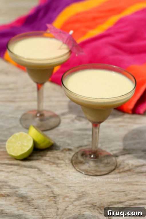 No Syrup Piña Colada Homemade Fresh, homemade No Syrup Piña Colada cocktail garnished with pineapple and cherry, embodying tropical vibes.