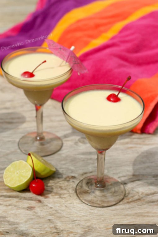 Easy Blender Piña Colada Recipe Two glasses of homemade No Syrup Piña Colada, ready to be enjoyed as a refreshing tropical drink.