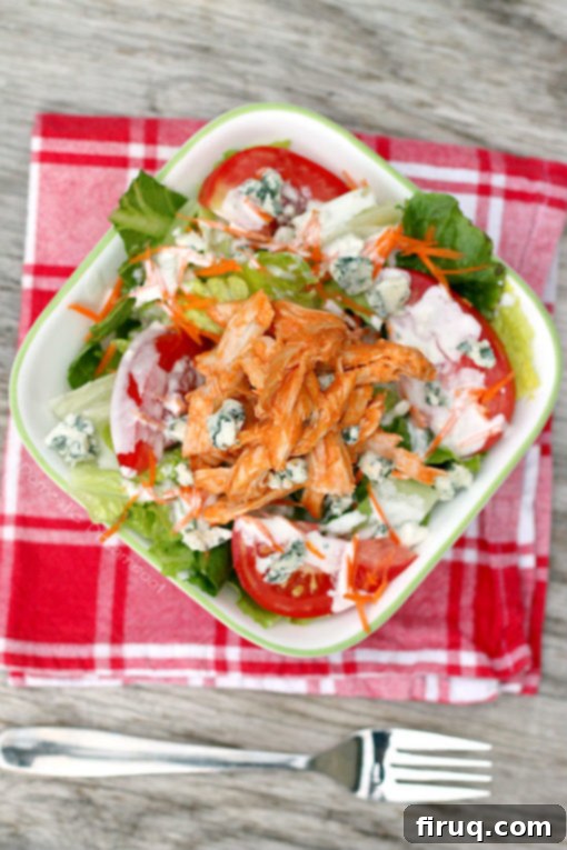 Buffalo Chicken Salad for Dinner Colorful Buffalo Chicken Salad arranged in a bowl with dressing