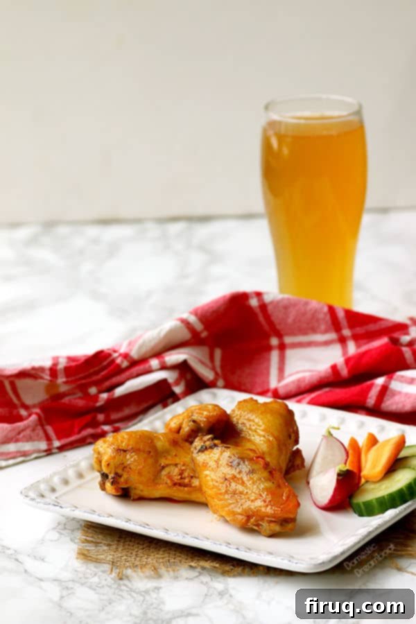 Perfectly golden and crispy baked hot wings ready to be sauced. Crispy Baked Hot Wings - Domestic Dreamboat #glutenfree #chickenwings #hotwings
