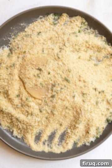Crispy Golden Italian Chicken Cutlets 9 A chicken breast fully dredged in seasoned breadcrumbs, patted down for even coating.