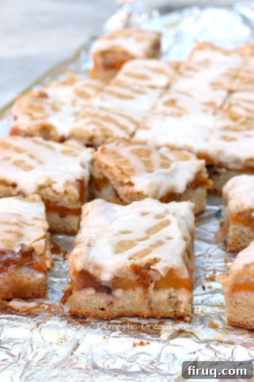 Delicious Peach Pie Bars Close-up of golden brown Peach Pie Bars with glaze