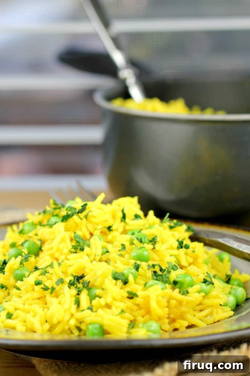 Golden Turmeric Pea Rice 3 rice on a plate with a pot in the background