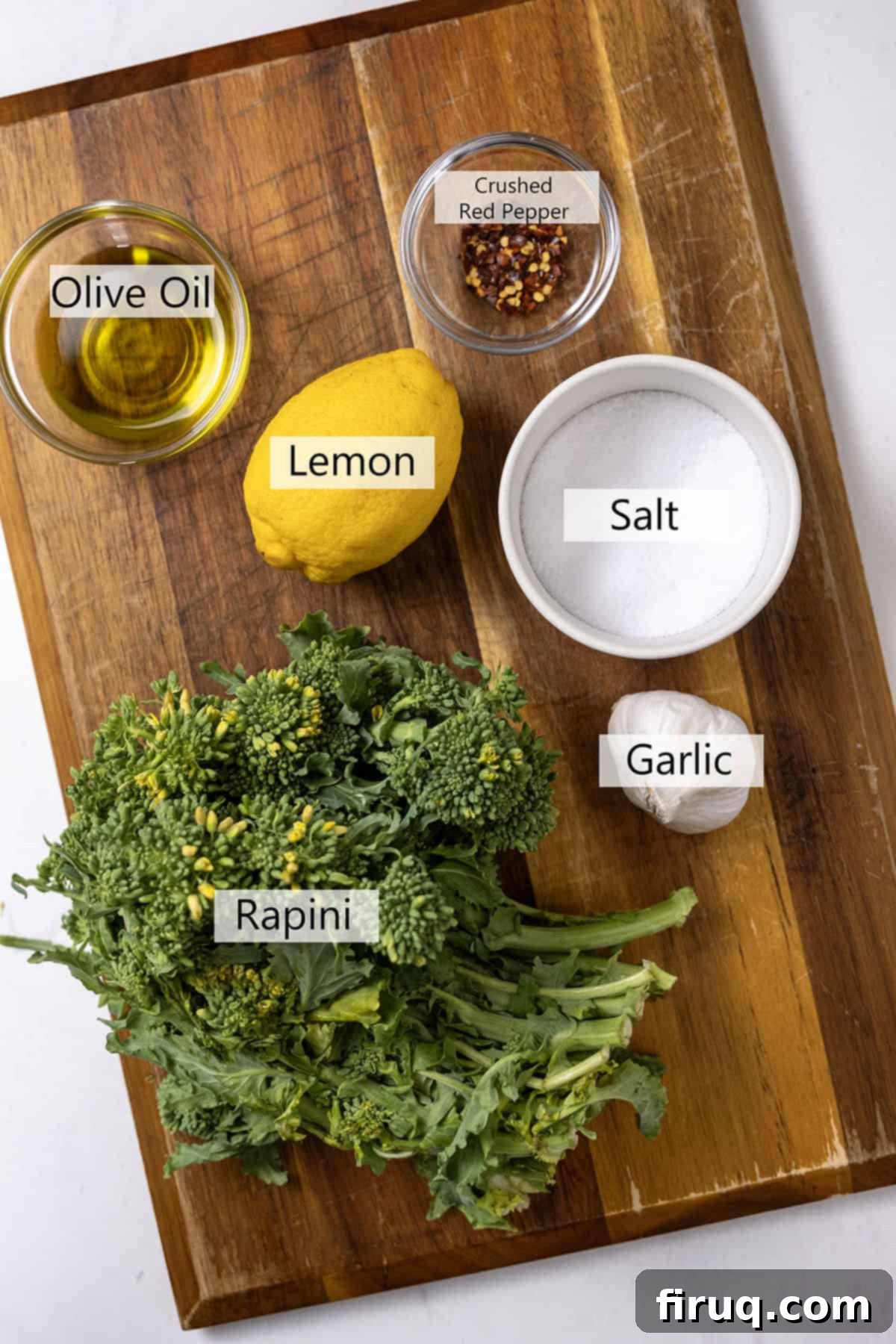 Vibrant Garlic Rapini 3 ingredients for sauteed rapini with garlic, including a fresh bunch of broccoli rabe, minced garlic, crushed red pepper flakes, lemon, and a bottle of olive oil