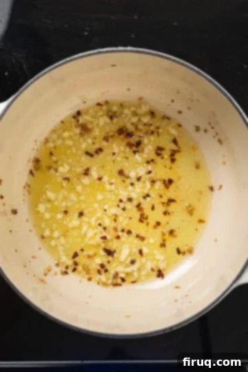 Vibrant Garlic Rapini 5 crushed red pepper flakes added to olive oil and garlic in a dutch oven