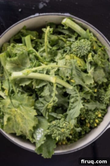 Vibrant Garlic Rapini 6 washed broccoli rabe added to olive oil, garlic, and red pepper in a dutch oven