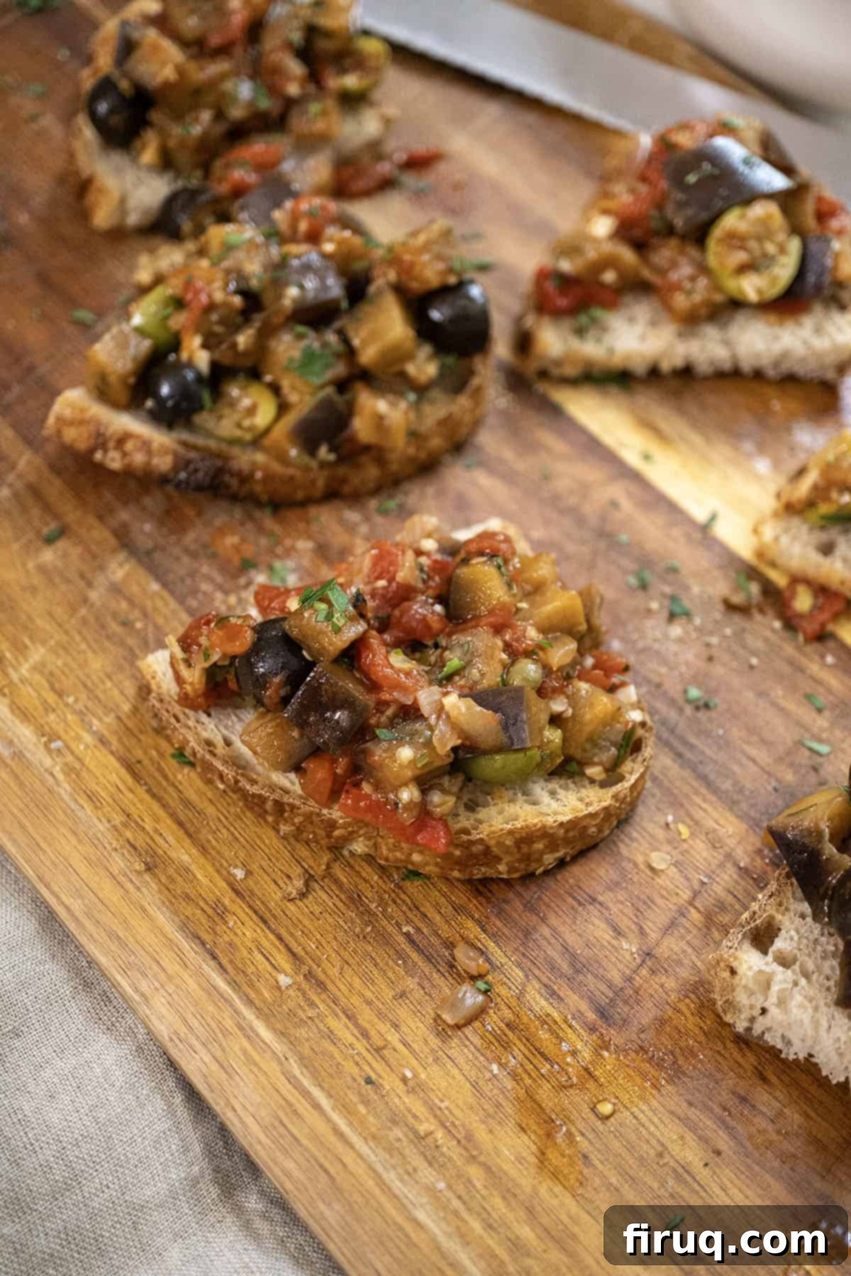 Tangy Eggplant Caponata 2 Delicious Eggplant Caponata served on crostini, garnished with fresh parsley.