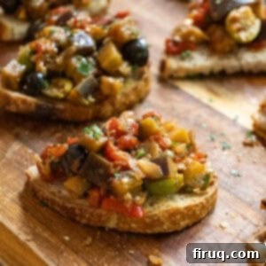 Tangy Eggplant Caponata 12 A bowl of fresh Eggplant Caponata with crostini, highlighting its delicious texture and vibrant colors.
