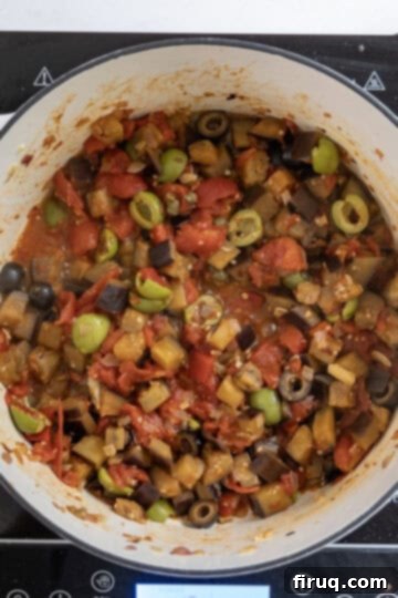 Tangy Eggplant Caponata 9 Eggplant Caponata simmering gently in a saucepan, allowing the flavors to meld beautifully.