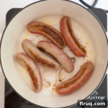 Grandma's Traditional Sunday Gravy 6 Searing sausage in the pot.