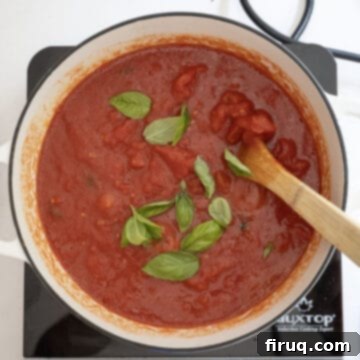 Grandma's Traditional Sunday Gravy 9 Tomatoes and basil added to the pot.