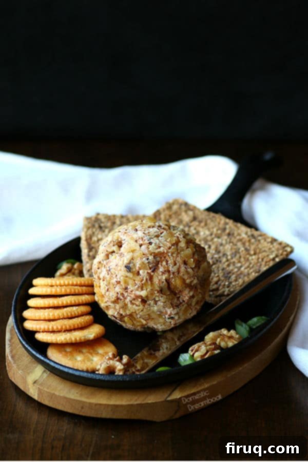 Cheddar Walnut Cheese Ball Ingredients A homemade cheese ball with crackers on a serving platter.