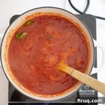 Nonna's Crispy Italian Meatballs 9 Tomato sauce simmering.