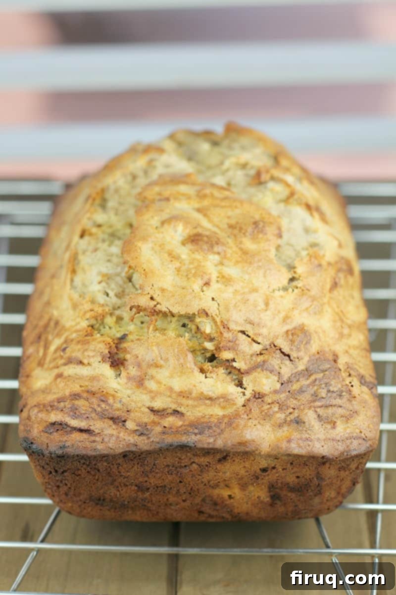 Heirloom Banana Bread 4 A golden-brown quick bread loaf cooling on a wire rack, ready to be sliced and enjoyed.