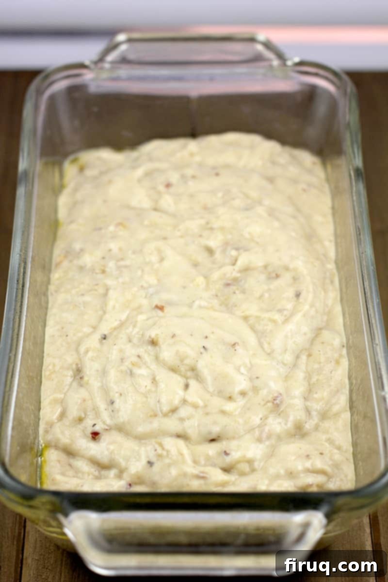 Heirloom Banana Bread 6 Dairy-free banana bread batter perfectly poured into a Pyrex loaf dish, ready for the oven.