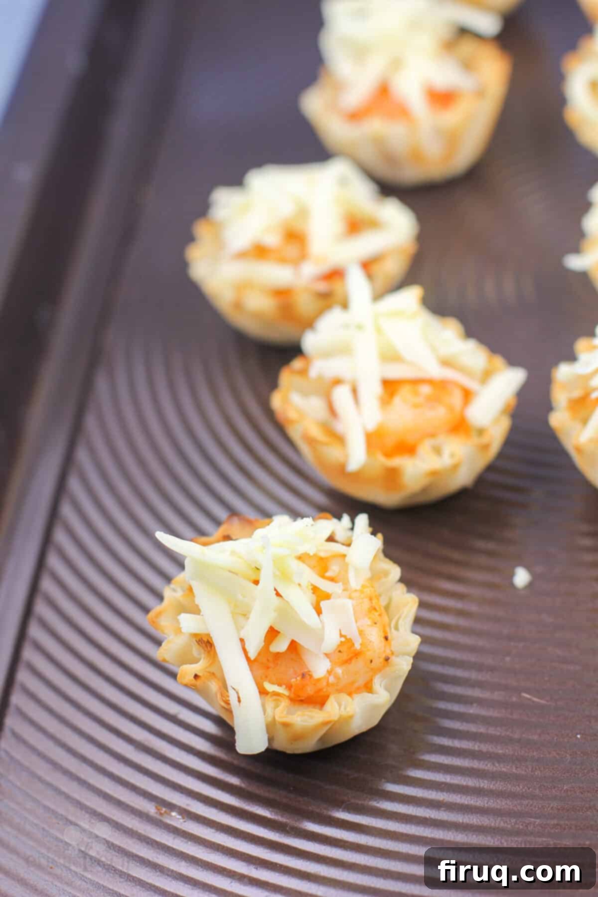Buffalo Shrimp Poppers 6 filled phyllo shells topped with cheese before cooking
