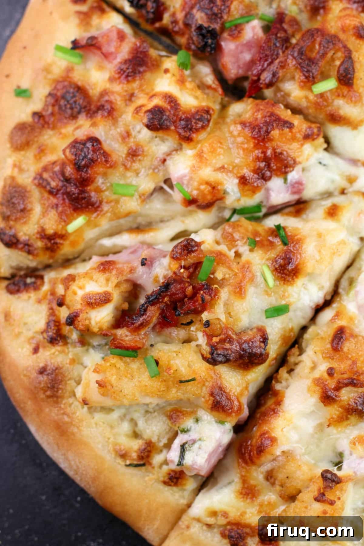 Chicken Cordon Bleu Pizza 2 Close-up view of a perfectly baked chicken cordon bleu pizza slice, showcasing the melted cheese and delicious toppings.