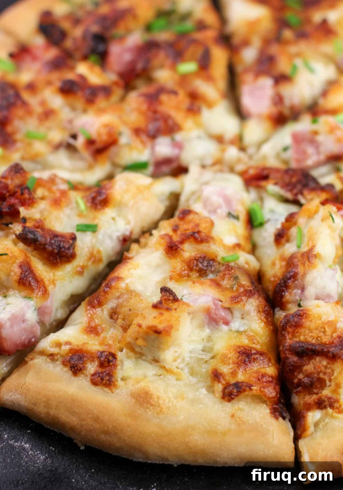 Chicken Cordon Bleu Pizza 8 Another close-up shot of a single slice of Chicken Cordon Bleu Pizza, emphasizing the delicious textures and toppings.