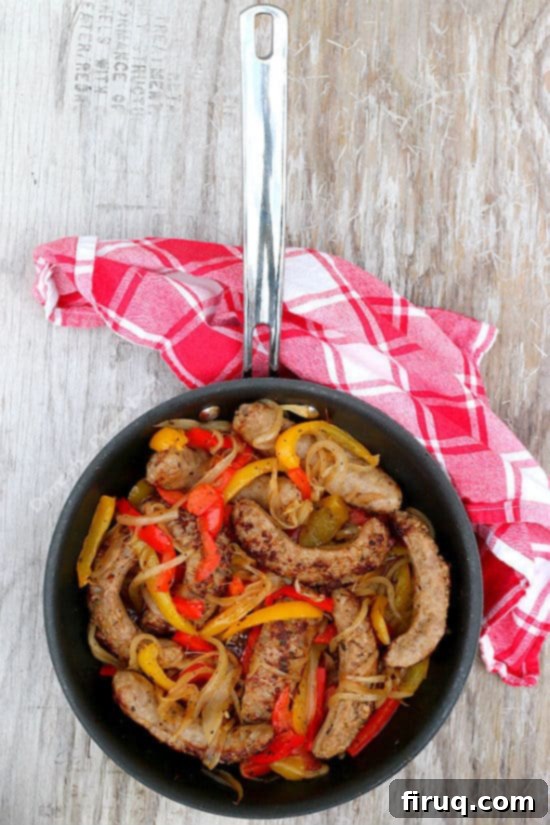 Delicious Italian Sausage with Onions and Bell Peppers Italian Sausage with Onions and Bell Peppers served in a bun
