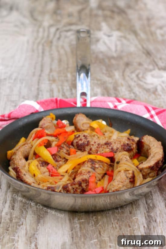 Skillet Italian Sausage and Peppers Close-up of cooked Italian Sausage with Onions and Bell Peppers in a skillet
