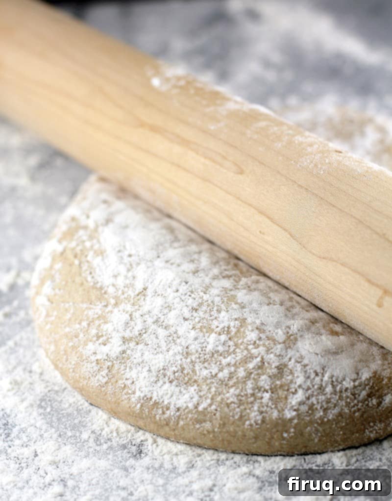 Healthy Whole Wheat Pizza Dough 2 a rolling pin on a mound of whole wheat dough