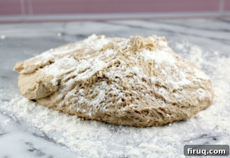 Healthy Whole Wheat Pizza Dough 6 view of the dough on a white marble surface after the first rise